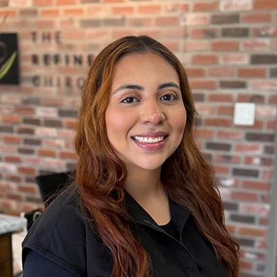 Mariah Lara smiling in a chiropractic clinic