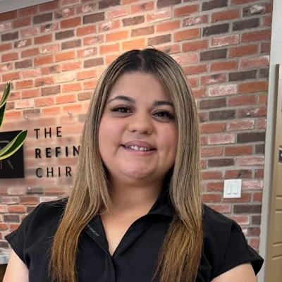 Melany Martinez smiling in a chiropractic clinic